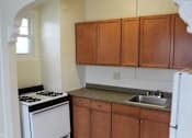 Thumbnail 8 of 31 - Kitchen with Wooden Cabinets at Lifestyle Apartments at Syracuse, Syracuse, NY, 13203