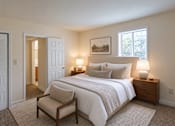 Thumbnail 14 of 14 - A bedroom with a bed, chair, and lamp.