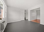 Thumbnail 4 of 30 - A room with white walls and a wooden floor.