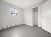 Thumbnail 8 of 30 - A room with a window, a door, and a wall socket.