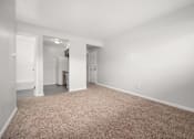 Thumbnail 12 of 30 - A room with a carpeted floor and white walls.