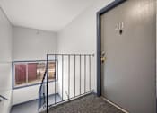 Thumbnail 19 of 30 - A room with a door numbered 211 and a window with a view of a red fence.