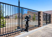 Thumbnail 6 of 15 - A black metal fence with a sign that says "Electric Vehicle" on it.