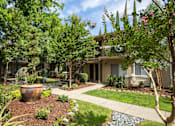 Thumbnail 8 of 22 - A walkway along one of the apartment buildings at Abby Creek Apartments, Carmichael, CA 95608 
