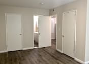 Thumbnail 5 of 20 - Bedroom with white doors and a wood floor