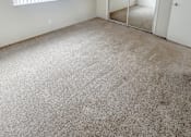 Thumbnail 23 of 34 - Monterey Manor vacant apartment bedroom with carpet , window and blinds, and a glass door closet