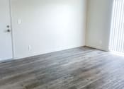 Thumbnail 25 of 34 - Monterey Manor Vacant Apartment Living Room with vinyl plank flooring and a patio glass door