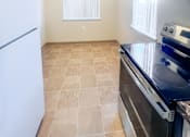 Thumbnail 18 of 34 - Monterey Manor vacant apartment kitchen and dining room with vinyl, a stover and fridge