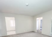 Thumbnail 14 of 34 - Monterey Manor vacant apartment living room with carpet and a wall heater