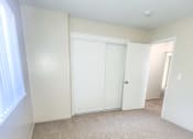 Thumbnail 33 of 34 - Monterey Manor vacant apartment bedroom with carpet , window and blinds, and a closet