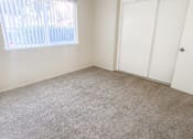 Thumbnail 31 of 34 - Monterey Manor vacant apartment bedroom with carpet , window and blinds, and a closet