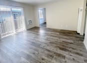 Thumbnail 24 of 34 - Monterey Manor Vacant Apartment Living Room with vinyl plank flooring and a patio glass door