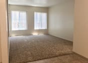 Thumbnail 10 of 20 - Living room with two windows and a carpeted floor
