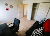 Thumbnail 7 of 19 - A black chair is in a room with a zebra print couch.