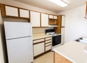 Thumbnail 14 of 14 - Kitchen with white cabinets and a black stove top oven at Maple Tree Apartments in LaPorte, IN