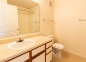 Thumbnail 12 of 14 - Bathroom with a sink toilet and mirror at Maple Tree Apartments in LaPorte, IN