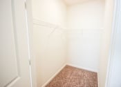 Thumbnail 29 of 34 - A small, empty room with a carpeted floor.