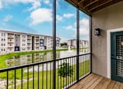 Thumbnail 81 of 94 - a balcony with a view of a pond and Vantage apartment buildings