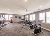 Thumbnail 18 of 57 - The gym at Swiftwater Luxury apartments with exercise equipment