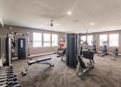Thumbnail 19 of 57 - fitness center with a weight machine and a bench at Swiftwater apartments in Port Charlotte, FL