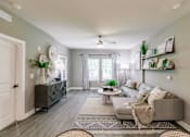 Thumbnail 42 of 94 - a living room with a couch and a table at Vantage Luxury Apartments in Cape Coral, Fl