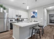 Thumbnail 25 of 42 - a kitchen with a counter top and a stainless steel refrigerator