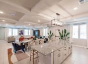 Thumbnail 15 of 57 - an open kitchen and living room with a granite counter top in swiftwater's clubhouse in port charlotte