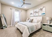 Thumbnail 69 of 94 - a bedroom with a bed and a ceiling fan