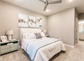 Thumbnail 68 of 94 - a bedroom with a bed and a ceiling fan