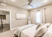 Thumbnail 70 of 94 - a bedroom with a large bed and a ceiling fan