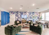 Thumbnail 6 of 57 - a living room with green couches and chairs and a table with chairs at Swiftwater apartments in Port Charlotte, FL
