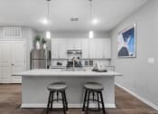 Thumbnail 24 of 42 - an island with two stools in front of a kitchen
