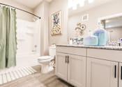 Thumbnail 71 of 94 - a bathroom with a shower and a toilet and a sink
