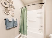 Thumbnail 78 of 94 - a bathroom with a shower and towels and a sink