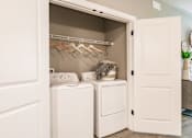 Thumbnail 54 of 94 - a small closet with a washer and dryer