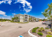 Thumbnail 2 of 57 - an empty parking lot in front of Swiftwater apartments in Port Charlotte, FL