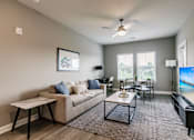 Thumbnail 60 of 94 - an open living room and dining room with a couch and a tv