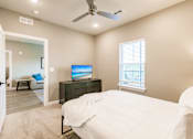 Thumbnail 86 of 94 - a bedroom with a bed, tv, and dresser at Vantage apartments in cape coral