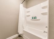 Thumbnail 92 of 94 - a bathroom with a tub and a shower and a white shower curtain