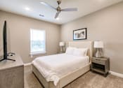 Thumbnail 85 of 94 - a bedroom with a bed and a ceiling fan