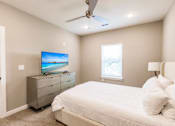 Thumbnail 87 of 94 - the master bedroom has a large bed and a tv