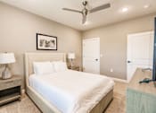 Thumbnail 84 of 94 - a bedroom with a night stand at Vantage Luxury Apartments in  Cape Coral, FL