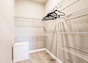 Thumbnail 80 of 94 - a spacious closet with shelves