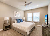 Thumbnail 74 of 94 - a bedroom with a bed and night stand at Vantage Luxury Apartments in  Cape Coral, FL