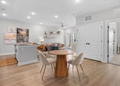 Thumbnail 9 of 83 - A kitchen with a dining table and chairs in the middle of the room.
