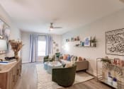 Thumbnail 25 of 57 - a living room with furniture and a ceiling fan at  a living room with tables and chairs and a ceiling fan at Swiftwater Luxury apartments in Port Charlotte, FL