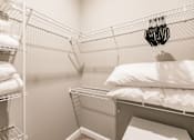 Thumbnail 88 of 94 - a walk in closet with a bed in it and a rack with white pillows