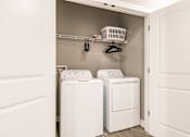 Thumbnail 94 of 94 - a washer and dryer in a laundry room with white cabinets