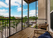 Thumbnail 65 of 94 - a balcony with two chairs and a view of a palm tree