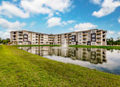 Thumbnail 15 of 94 - a large pond in front of an apartment building